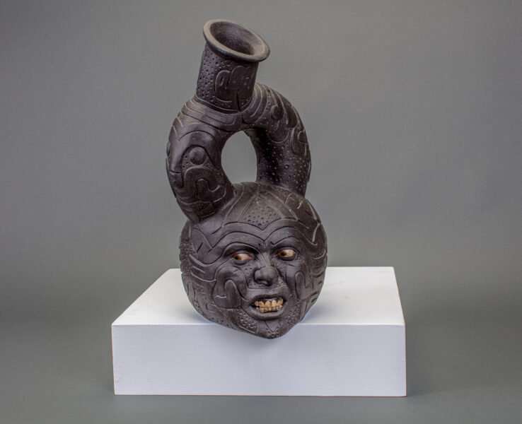 RAM Showcase: Bodies A circular ceramic vessel with many engravings, including a very angry and scared face.