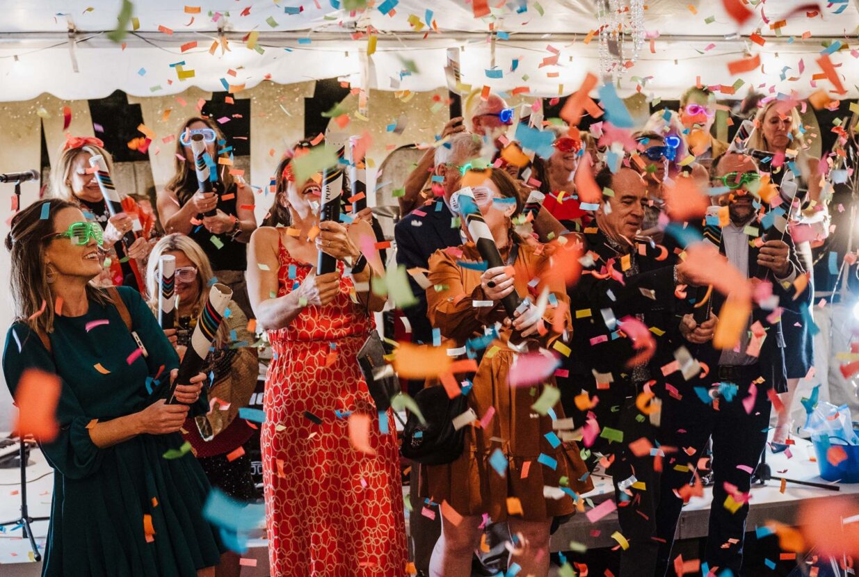 A group of people celebrating with confetti at a RAM event