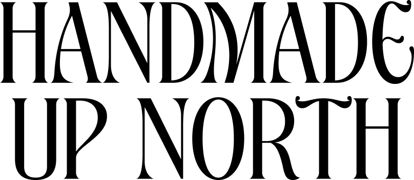 The image displays the phrase “HANDMADE UP NORTH” in large, ornate black lettering on a light background.