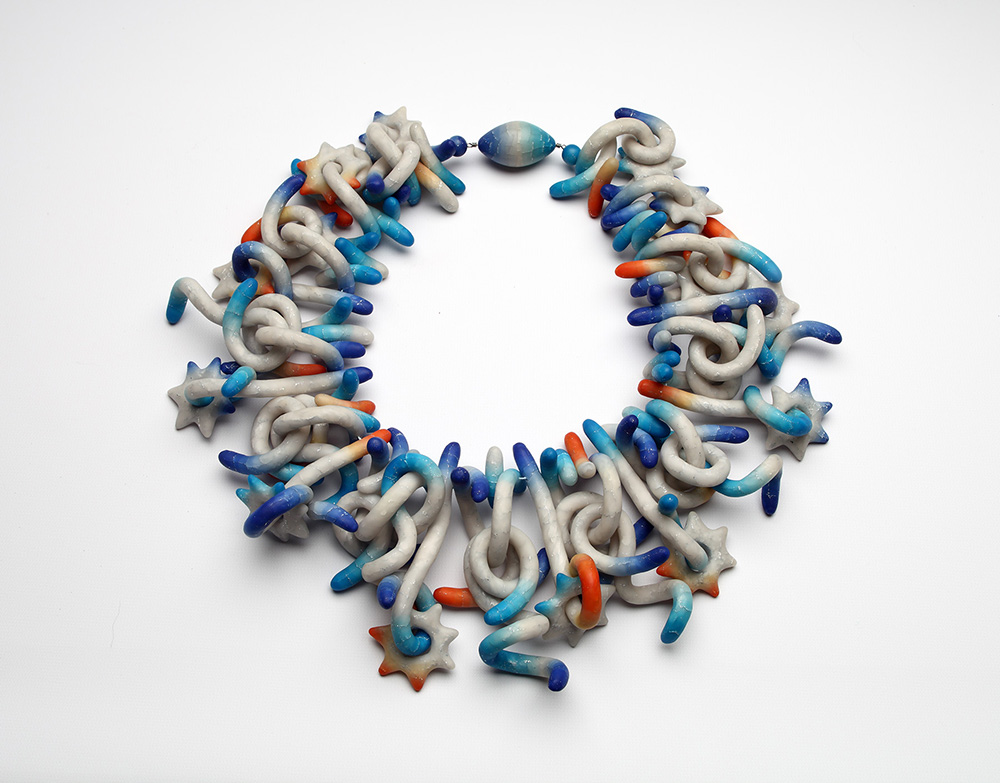 Polymer neckpiece with a multitude of various organic shapes