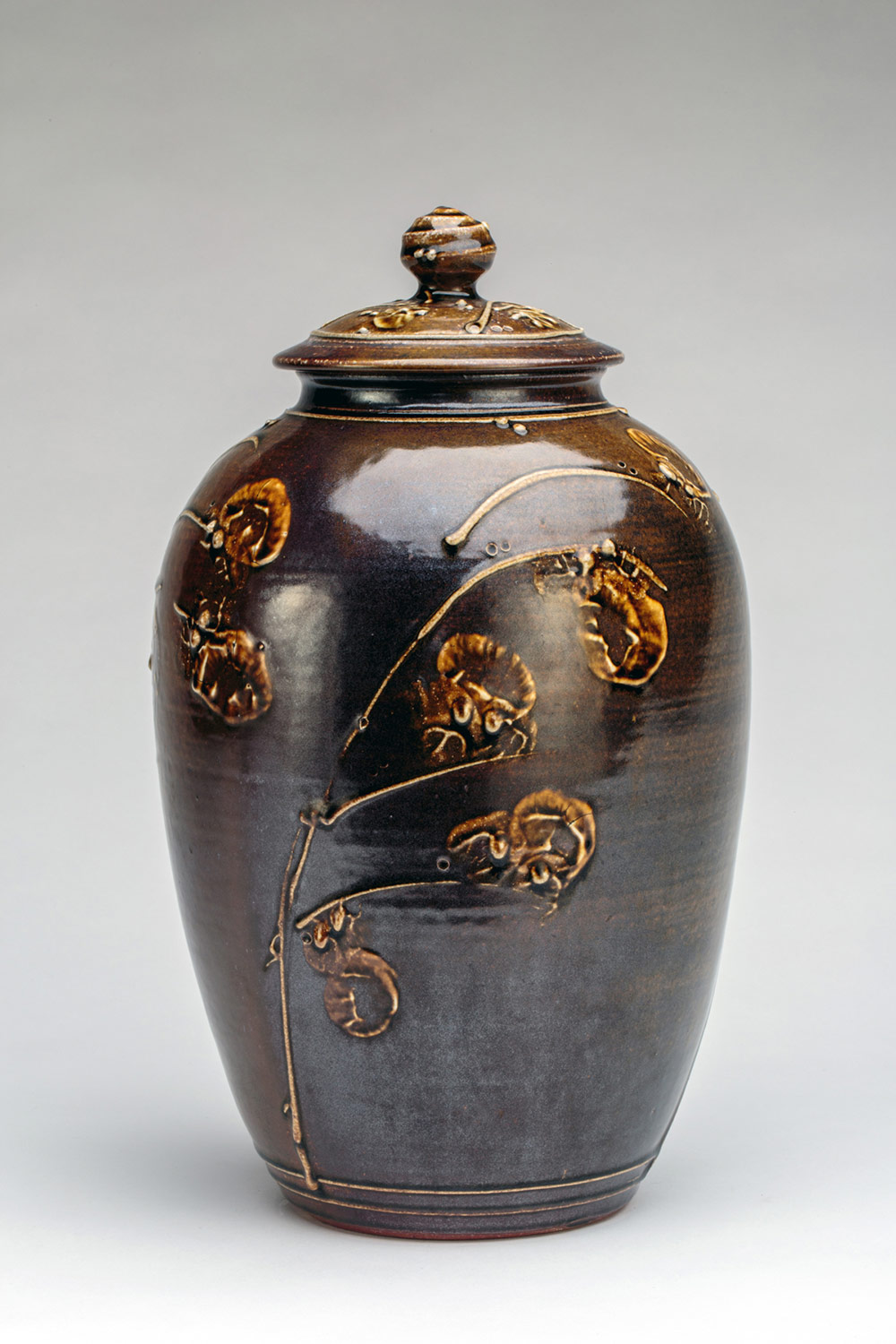 Brown jar with floral designs