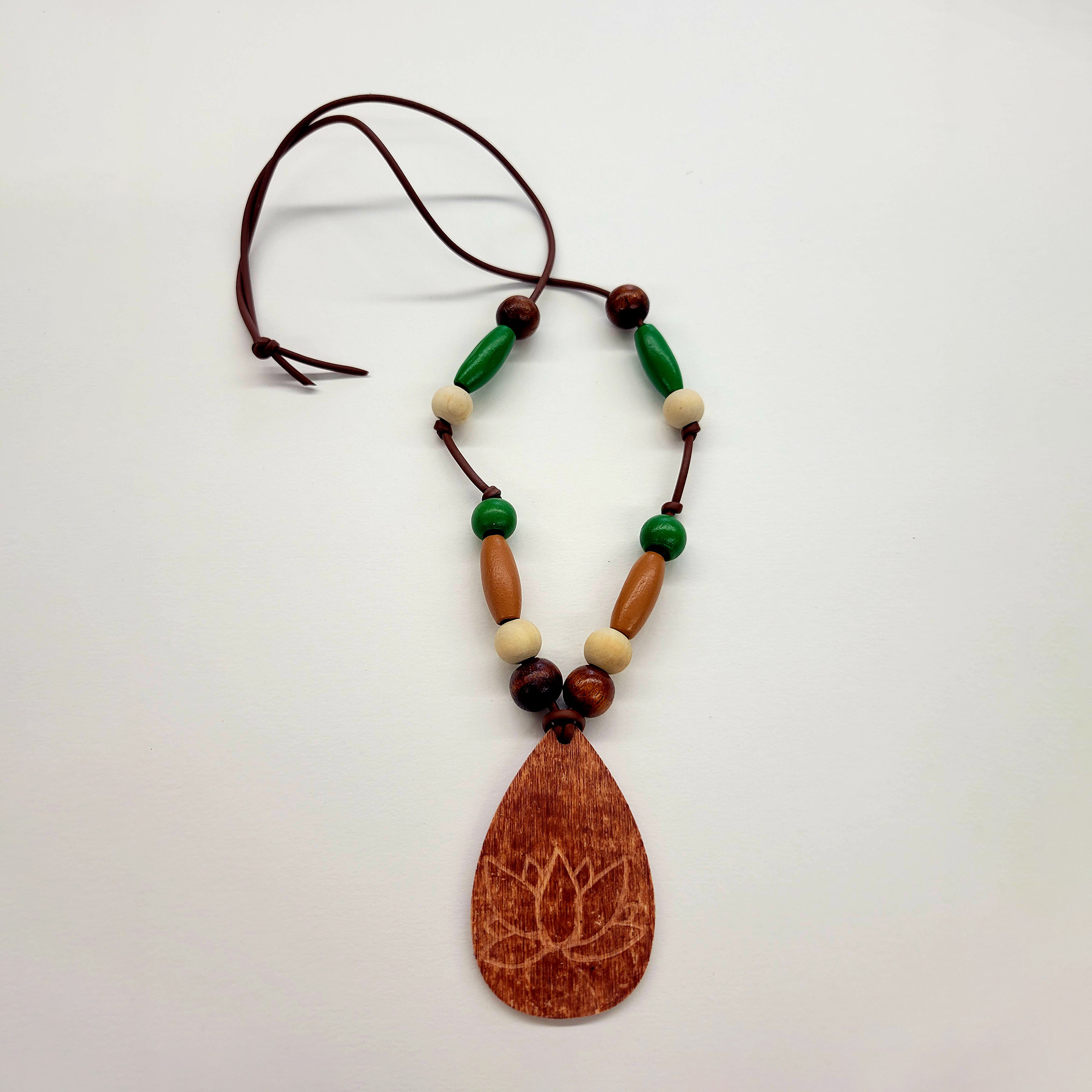 Beaded necklace with a wooden tag, which is etched with a lotus flower design