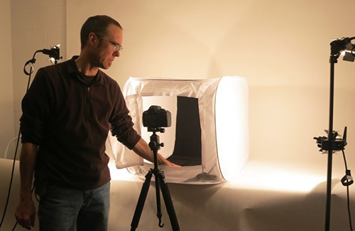 Man preparing a shoot at Wustum Museum's photography studio