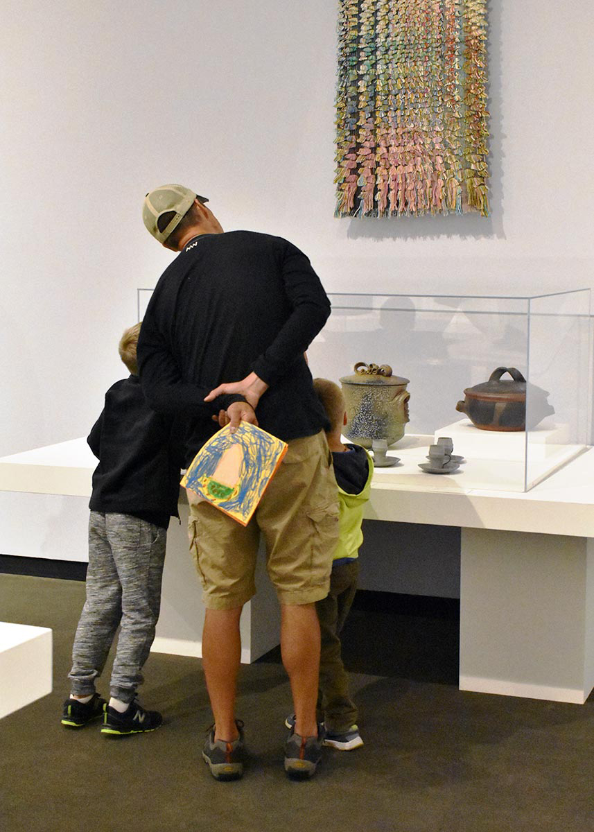 Man With two children viewing art in the RAM galleries